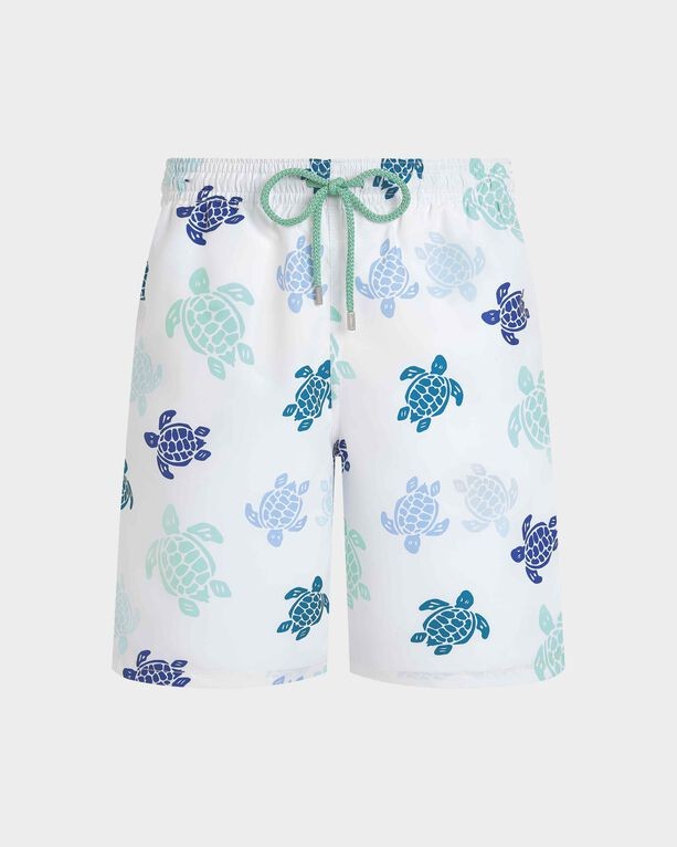 White swim shorts featuring a colorful turtle pattern in shades of blue and green, with an elastic waistband and a contrasting green drawstring, size XL.