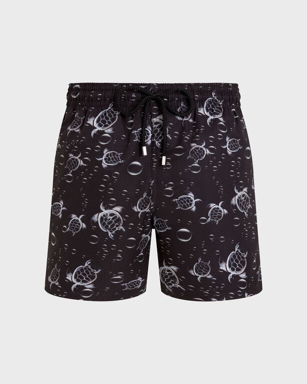 Black micro-perforated swim shorts featuring a 3D bubble turtle print, elastic waistband with drawstring, and lightweight, packable material, available in size XXXL.