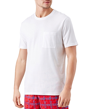 Beige organic cotton T-shirt by Vilebrequin, featuring a crew neckline, short sleeves, and a chest pocket, displayed on a model wearing red plaid swim shorts.