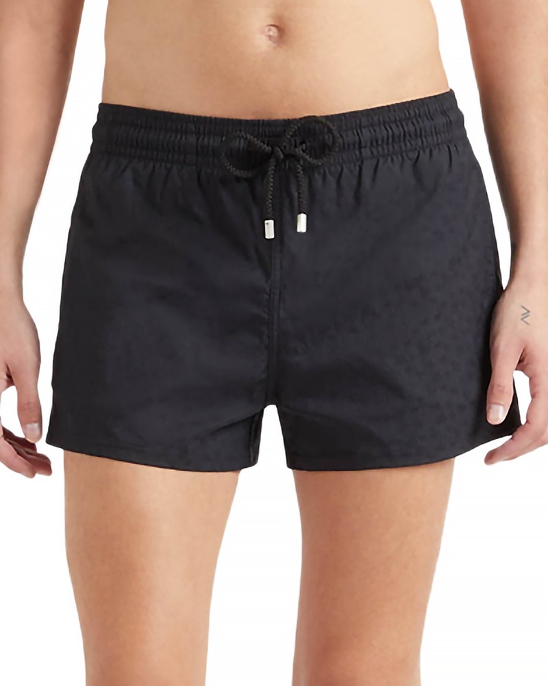 Black jacquard swim shorts featuring a turtle pattern, elastic waistband with drawstring, and a relaxed fit, designed for men in size XL by Vilebrequin.