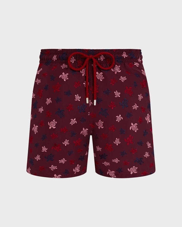 Red swim shorts featuring an embroidered turtle pattern in various shades, with an elastic waistband and drawstring, made from lightweight material, size S.