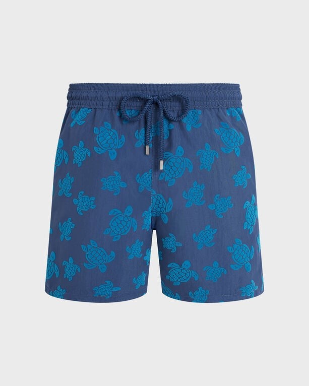 Blue swim shorts featuring a flocked turtle pattern, elastic waistband with drawstring, and made from lightweight material, available in size XXXL.