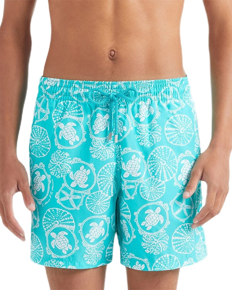 Turquoise swim trunks featuring a turtle and nautical-themed print, made from lightweight material with an elastic waistband and drawstring for a comfortable fit.