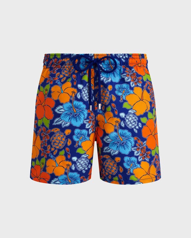 Blue swim shorts featuring a vibrant tropical turtle and floral print in orange, green, and blue, with an elastic waistband and drawstring for adjustable fit, size XS.