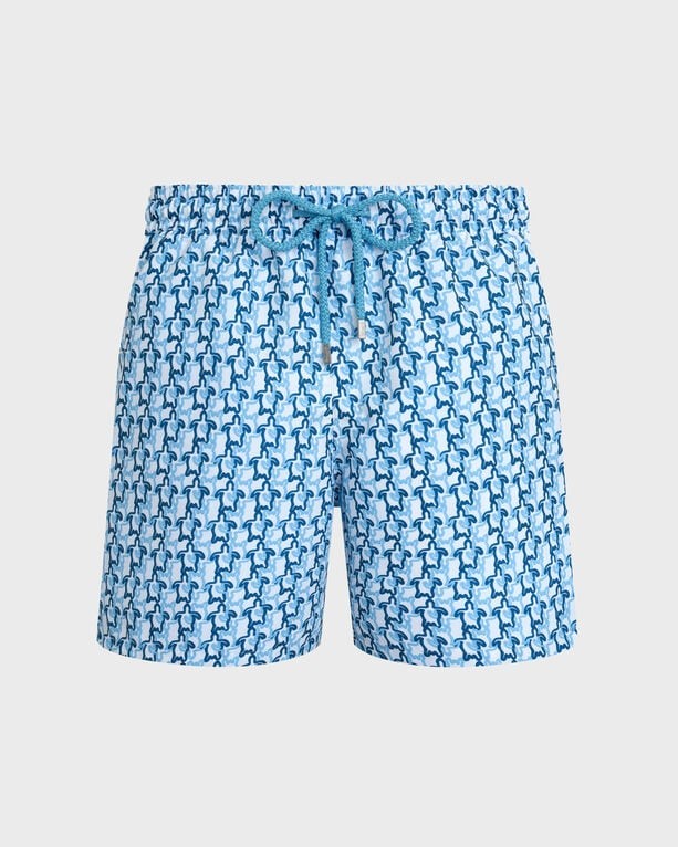 White swim shorts featuring a blue turtle pattern, made from lightweight material, with an elastic waistband and adjustable drawstring, in size XS.