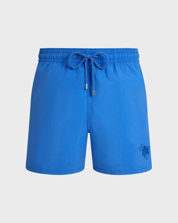 Bright blue swim shorts with an elastic waistband and drawstring, featuring a subtle logo on the lower left side, made from lightweight, quick-drying material.