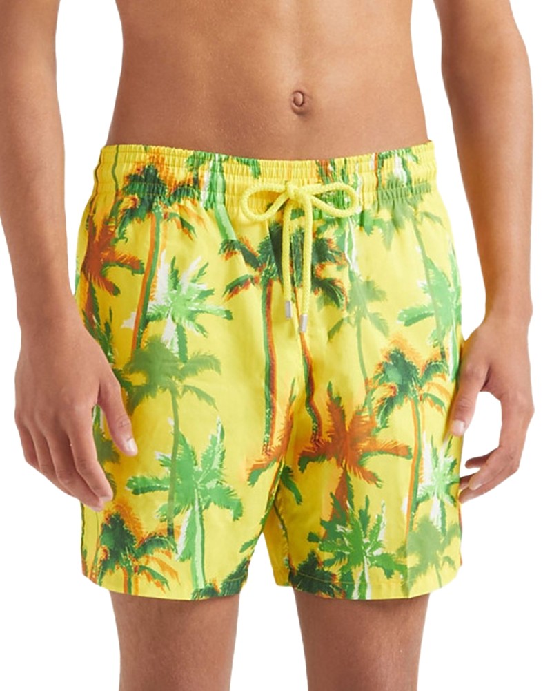Yellow swim shorts featuring a vibrant palm tree print in green and orange, with an elastic waistband and drawstring, made from ultra-light, packable material.