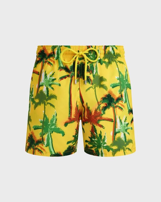 Bright yellow swim shorts featuring a vibrant palm tree print in green and red, with an elastic waistband and adjustable drawstring, made from ultra-light, packable material.