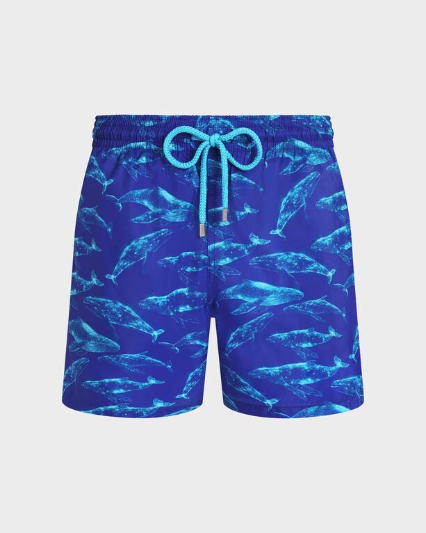 Ultra-light blue swim shorts featuring a vibrant whale print, elastic waistband with a turquoise drawstring, and a packable design, ideal for beachwear. Size L.