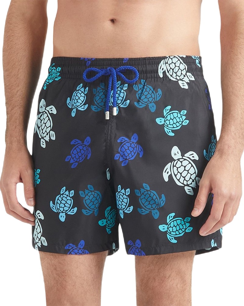 Black swim trunks featuring a colorful turtle print in shades of blue and white, with a drawstring waistband and a lightweight, quick-drying material.