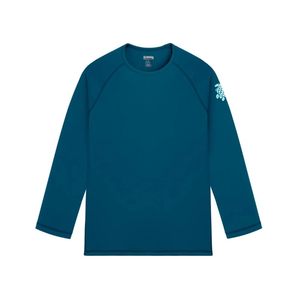 Blue long-sleeve rashguard made from UV-protective material, featuring a crew neck and a subtle logo on the sleeve, available in size XS.