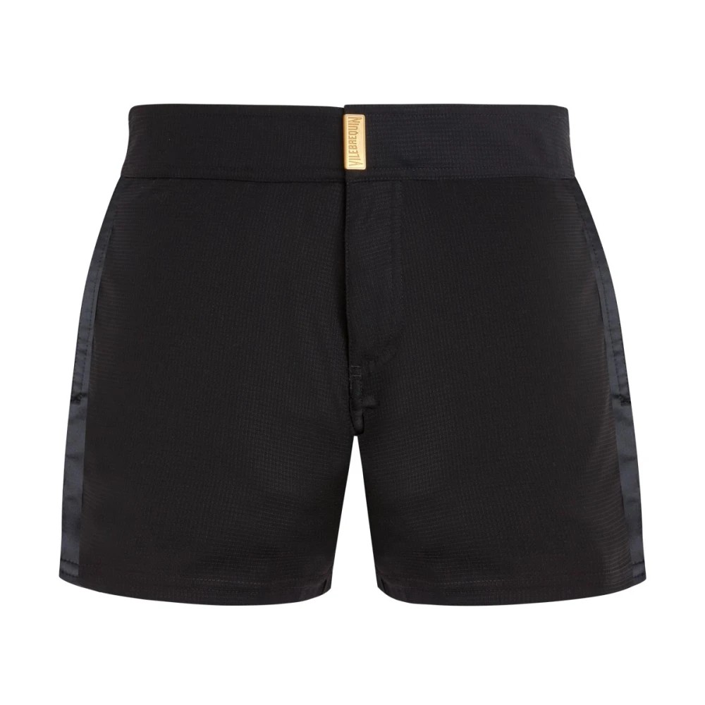Black wool swim shorts by Vilebrequin, featuring a tailored design, smooth texture, and a subtle sheen, with a gold logo tag on the waistband, available in size XXXL.