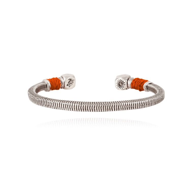 Silvered Jonc bracelet featuring a flexible design with orange sari thread accents, showcasing decorative ends with intricate patterns, by Vilebrequin X Gas Bijoux.
