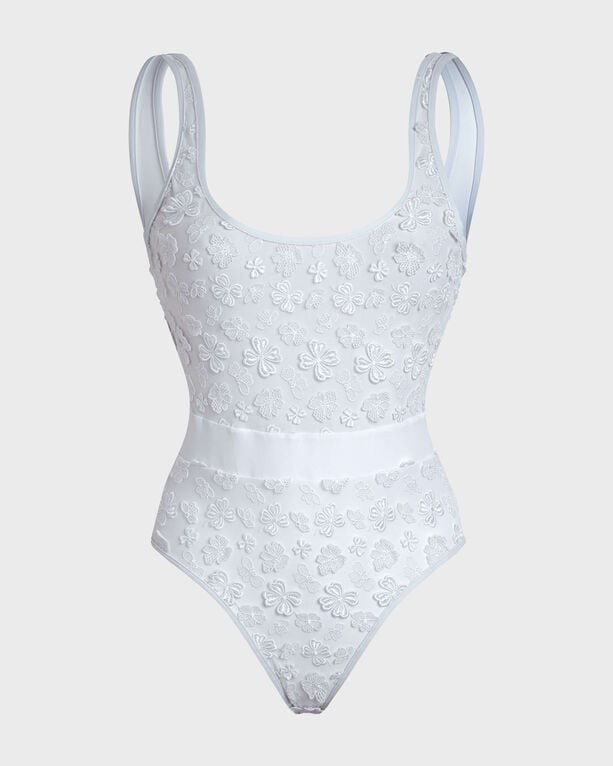 White one-piece swimsuit featuring embroidered flowers, adjustable straps, and a fitted silhouette, made from a soft, stretchy material, size M.