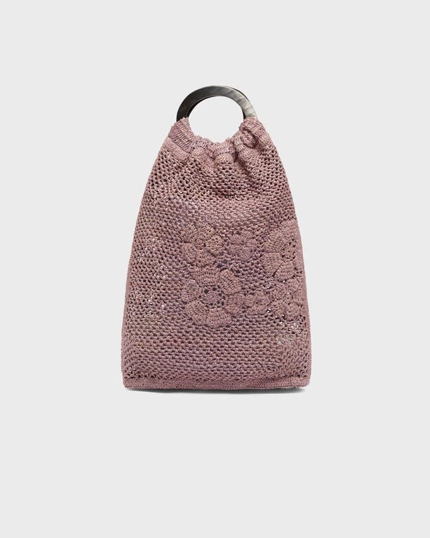 Raffia handbag in soft pink with a textured floral design, featuring a cinched top and a circular handle, designed by Vilebrequin.