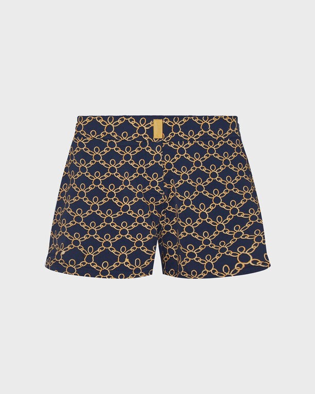 Blue women's swim shorts featuring a turtle chain pattern in gold, made from stretchy material, with a flat belt design and a shorty cut, size XS.