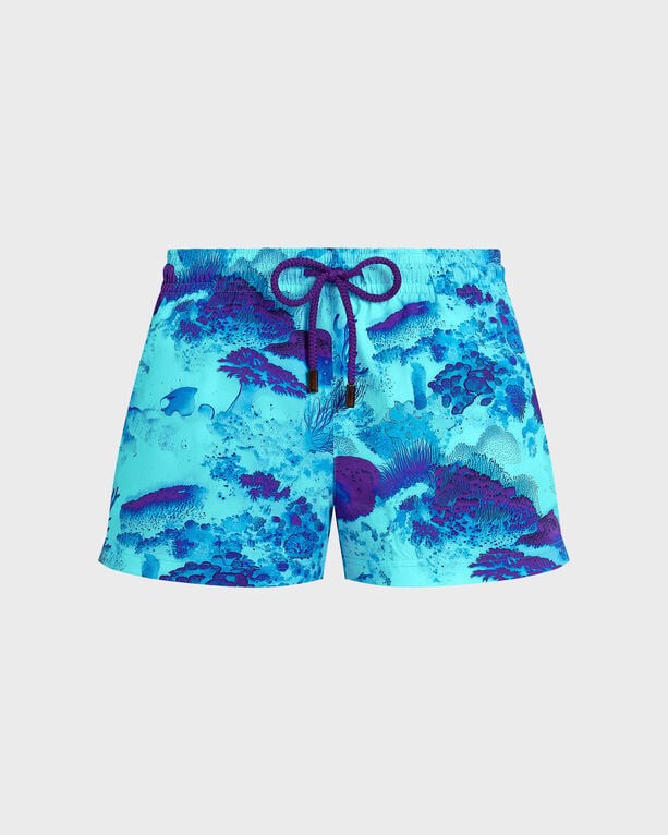 Women’s stretch swim shorts in a vibrant coral reef pattern, featuring shades of blue and purple, with an elastic waistband and drawstring, size S.