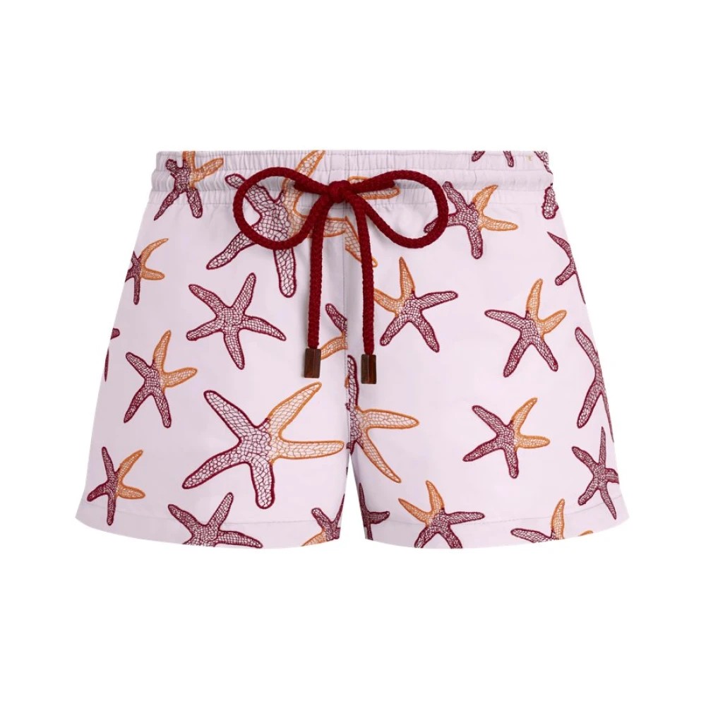 Pink swim shorts featuring an embroidered starfish pattern in orange and burgundy, with a drawstring waistband and a shorty cut, size XS.