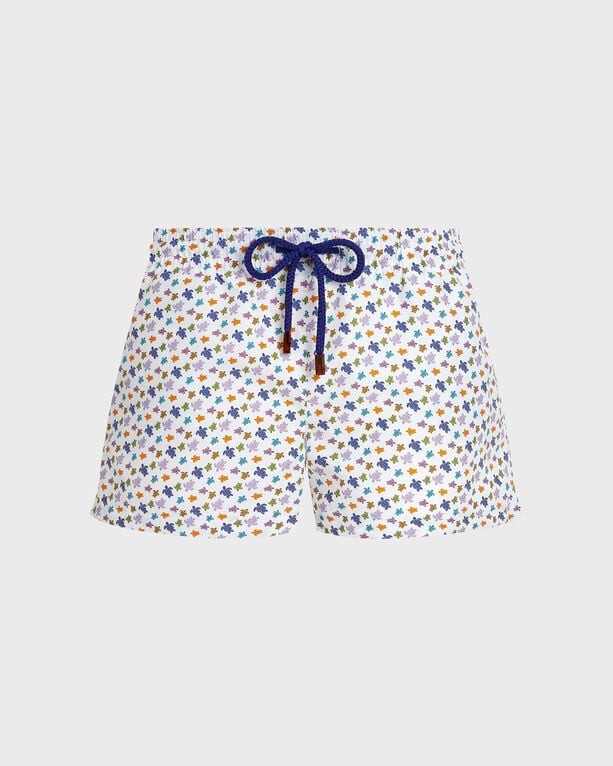 White swim shorts featuring a colorful turtle print, drawstring waist, and a shorty cut, made from lightweight fabric, size M.