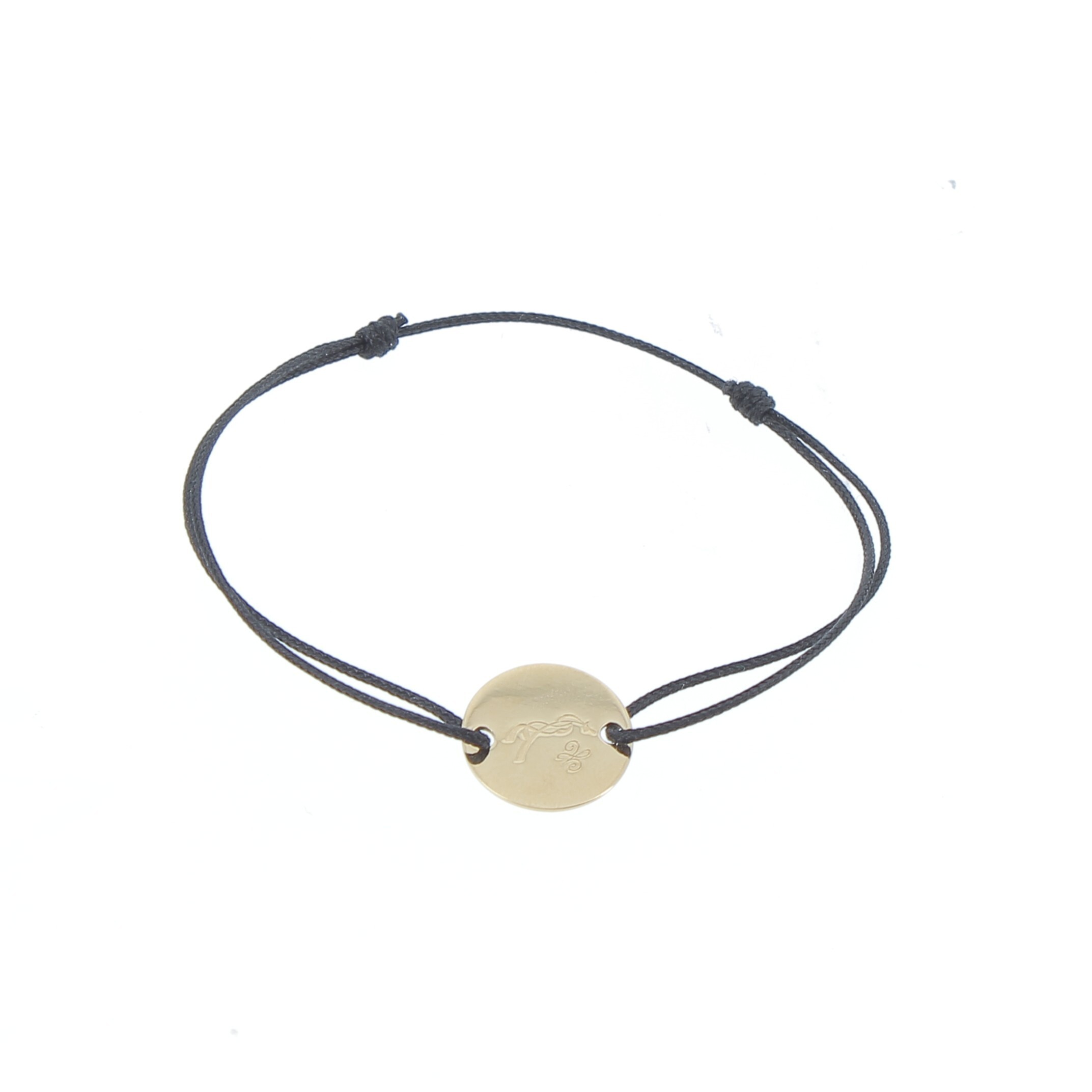 A delicate black cord bracelet featuring a round gold-tone charm with a subtle engraved design, showcasing a minimalist and elegant style.