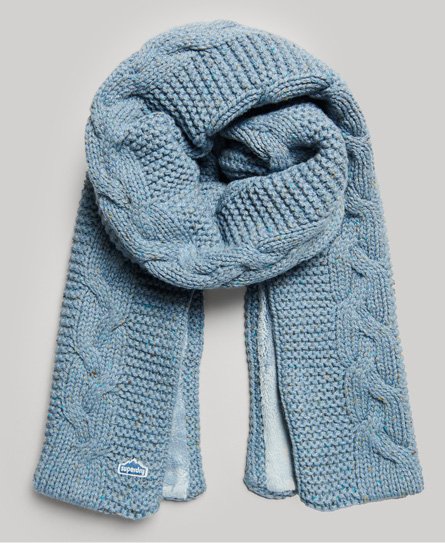 Soft, light blue cable knit scarf by Superdry, featuring textured patterns and a cozy, chunky design, with a small branded tag visible.