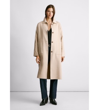 Beige wool-blend coat by Pepe Jeans with a collared neckline, button front, and side pockets, paired with a black top and dark jeans.