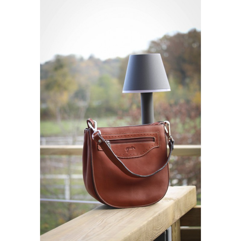 Stylish women's handbag in rich brown leather with a curved silhouette, featuring a zippered front pocket and a detachable shoulder strap.