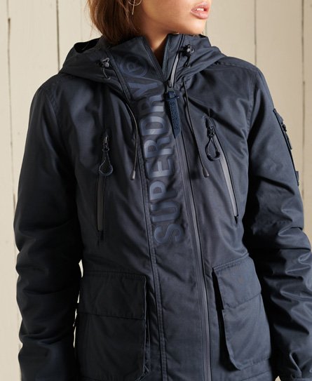 Navy blue women's microfiber waterproof jacket featuring a hood, zippered pockets, and embossed Superdry logo on the front.