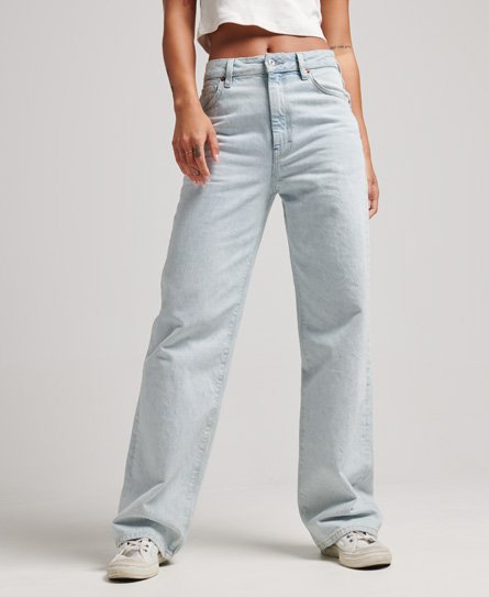 Light blue wide leg jeans made from vintage organic cotton, featuring a high waist and relaxed fit, styled with a cropped top and white sneakers.
