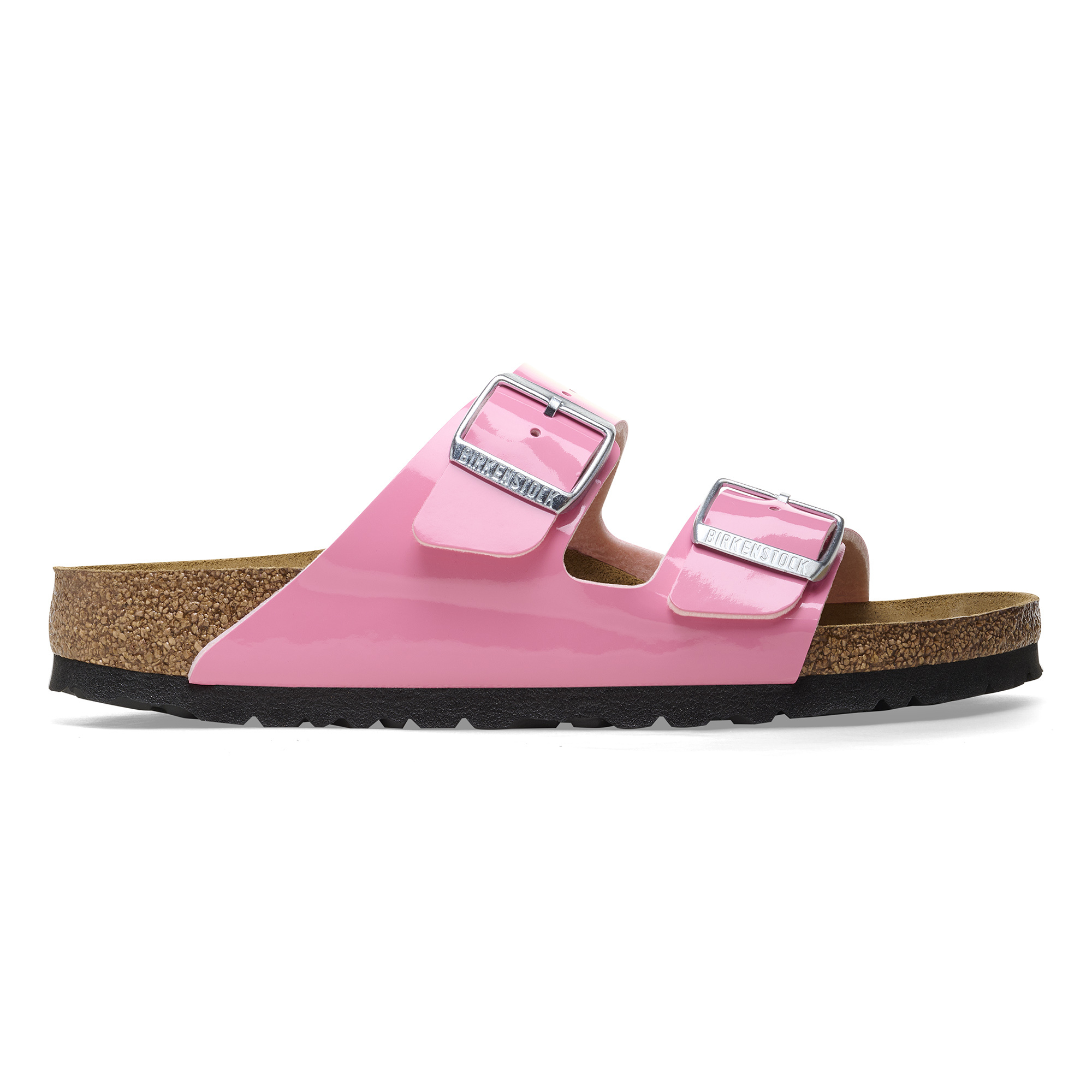 Pink patent Birko-Flor sandals featuring two adjustable straps with silver buckles, a cork footbed, and a black rubber outsole.