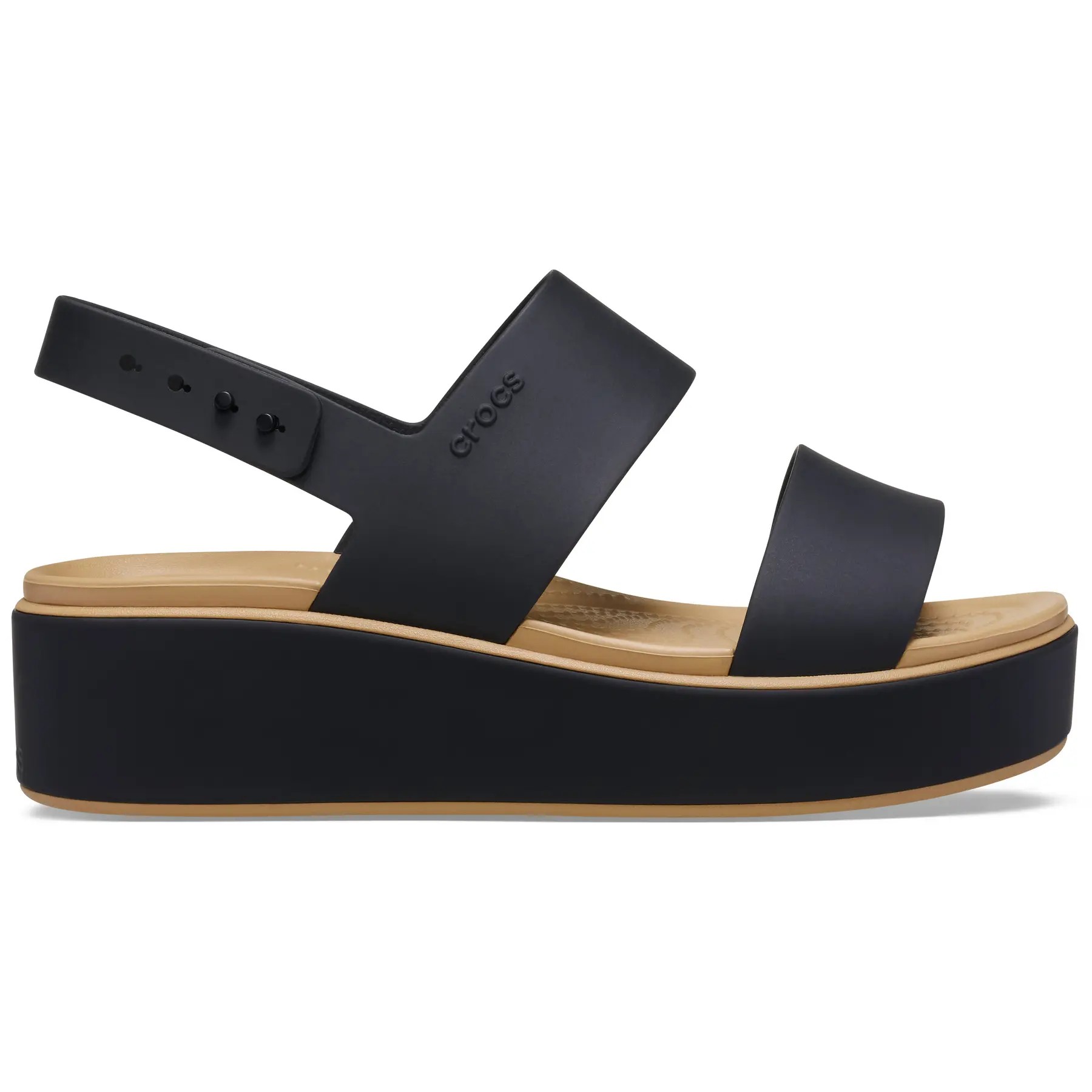 Black matte low wedge sandals by Crocs feature two wide straps, a cushioned footbed, and a thick platform sole with a tan accent.