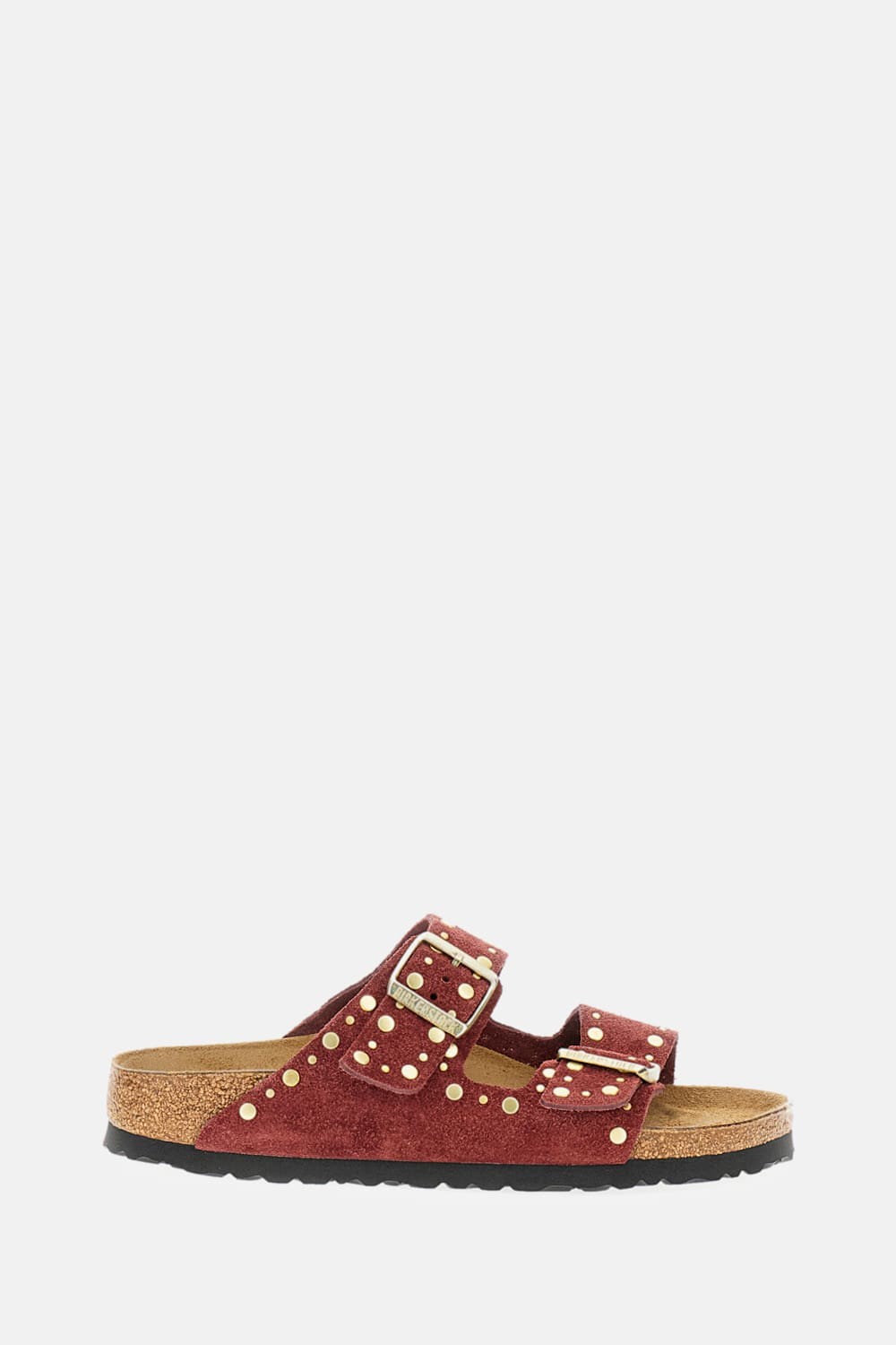 Red suede leather sandals featuring two adjustable straps with rivet details and a cork footbed, set on a black rubber sole.