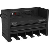 Black Sealey power tool storage rack with drawer, power strip, and multiple slots for tools, 560mm wide.