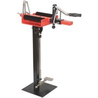 Red and black Sealey manual tyre spreader with stand, featuring a hand crank and adjustable arms on a sturdy base.