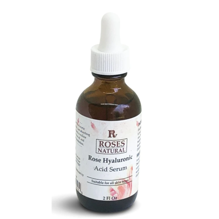 Brown glass dropper bottle with a white dropper cap, labeled "Roses Natural Rose Hyaluronic Acid Serum," featuring floral graphics and a 2 fl oz capacity.