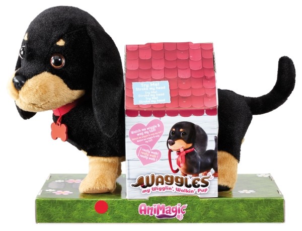 Plush black and tan puppy with a red collar, standing beside a colorful box featuring a doghouse design, showcasing its wiggling and walking features.