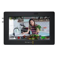 Blackmagic Design HYPERD/AVIDA03/5 Broadcast Monitor features a sleek black frame, a 5-inch display, and visible control buttons with a vibrant image of a woman cooking in a kitchen setting.