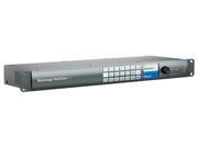 Blackmagic Design MultiView 16 in a sleek gray metal casing, featuring multiple input buttons, a large control knob, and a blue status display for video monitoring.
