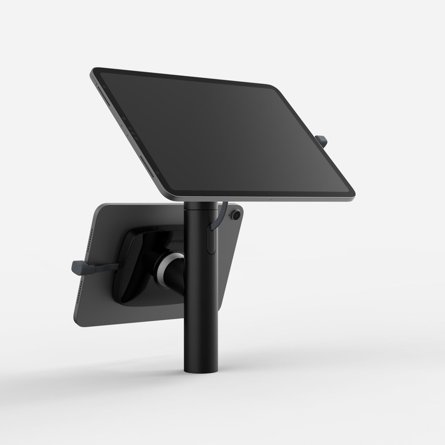 Black Bouncepad Core Twin tablet stand features a sleek design, adjustable angle, and compatibility with all USB-C devices, mounted on a sturdy pole.