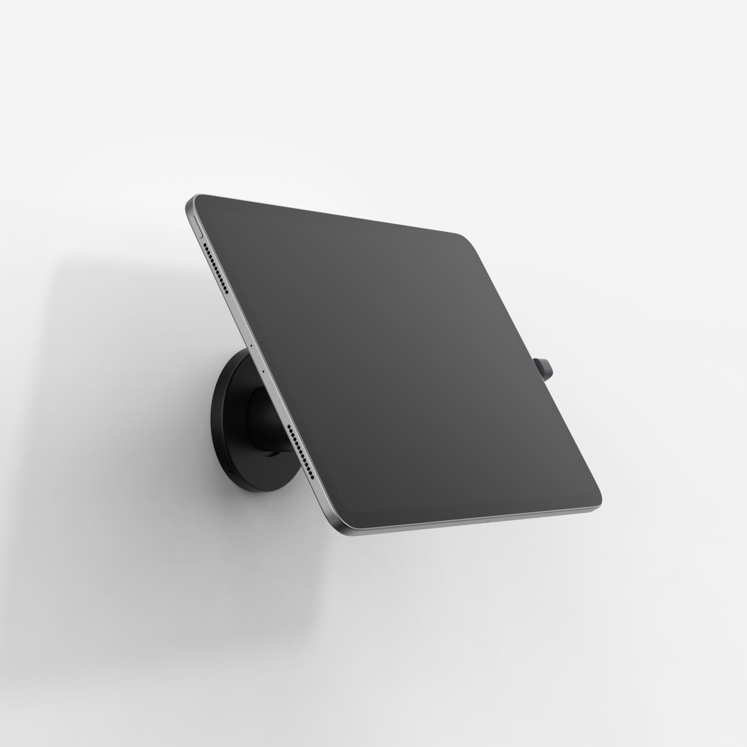 Black Bouncepad Core Wallmount securely holds USB-C tablets, featuring a sleek design with a flat, angled surface for optimal viewing and easy access.