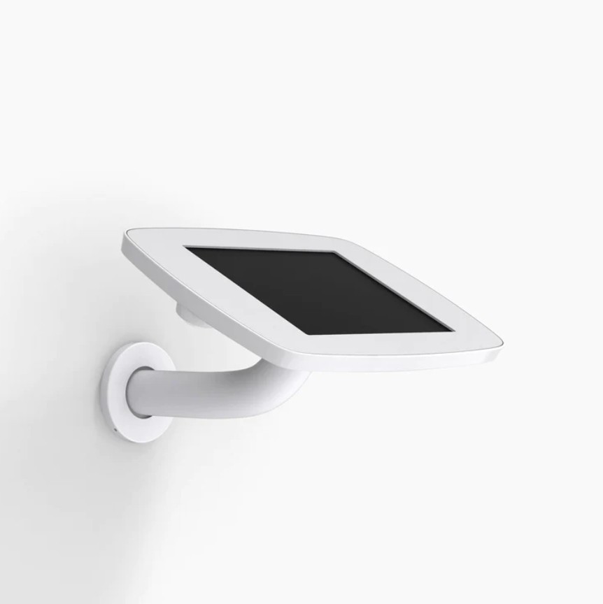 White Bouncepad Original Branch with a sleek design, featuring an exposed front camera and home button, mounted on a wall with a curved arm for optimal viewing.