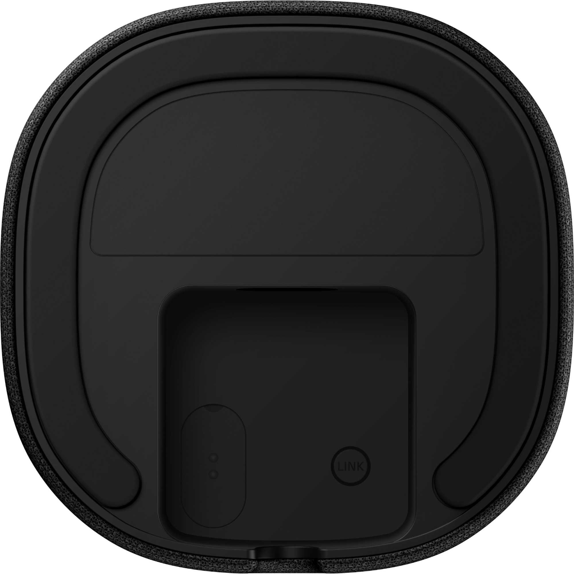 Black wireless rear speaker with a sleek, rounded design, featuring a textured surface and a recessed area for connectivity, designed for the Sony BRAVIA Theatre system.