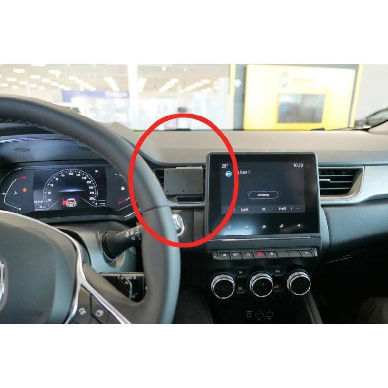 Black passive holder for mobile phones/smartphones mounted on a car dashboard, featuring a sleek design and sturdy material, positioned near the steering wheel and infotainment screen.