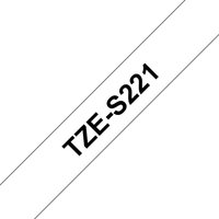 White Brother TZE-S221 label-making tape with bold black text reading "TZE-S221" diagonally across the tape.
