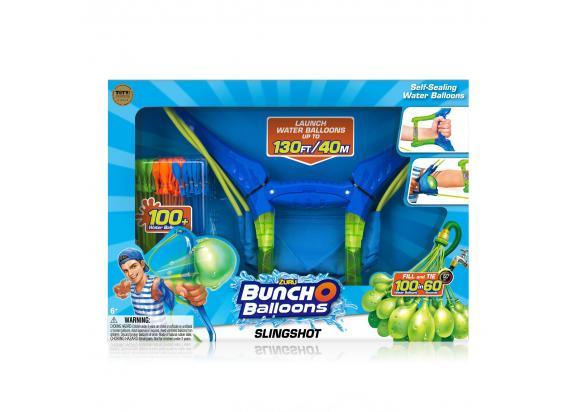 Brightly colored packaging featuring a blue and green slingshot for launching water balloons, with a cartoon character and images of self-sealing balloons included.