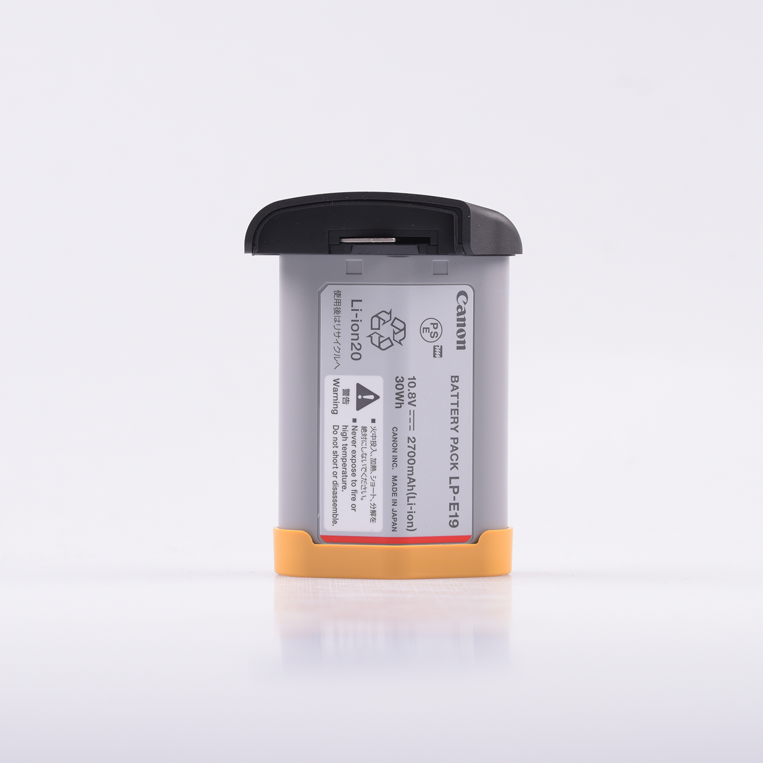 Canon LP-E19 Battery Pack in gray with a black top and orange base, featuring safety labels and specifications on the side for lithium-ion use.