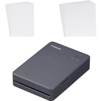Black Canon SELPHY QX20 photo printer, compact design, with two stacks of blank photo paper.