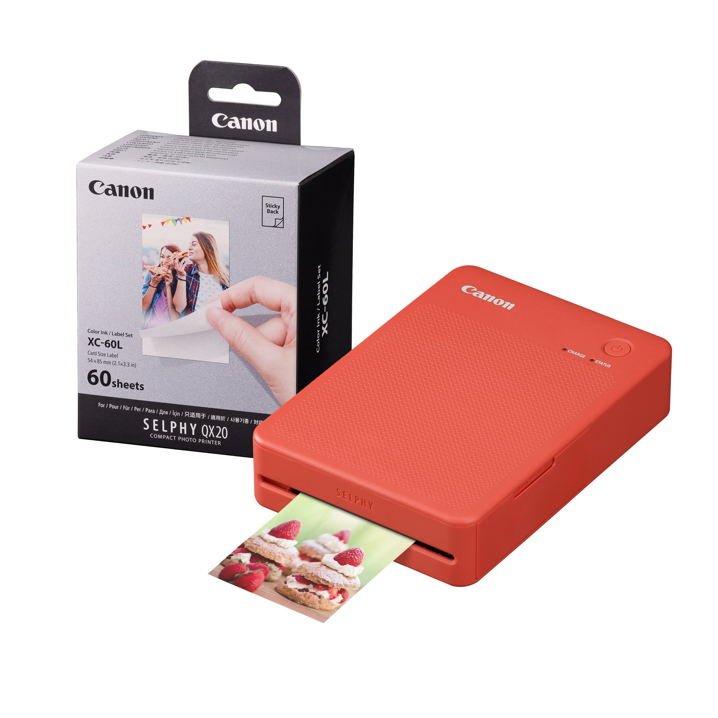 Terracotta red Canon Selphy QX20 instant photo printer with a textured finish, accompanied by a box of 60 sheets, printing a colorful photo of desserts.