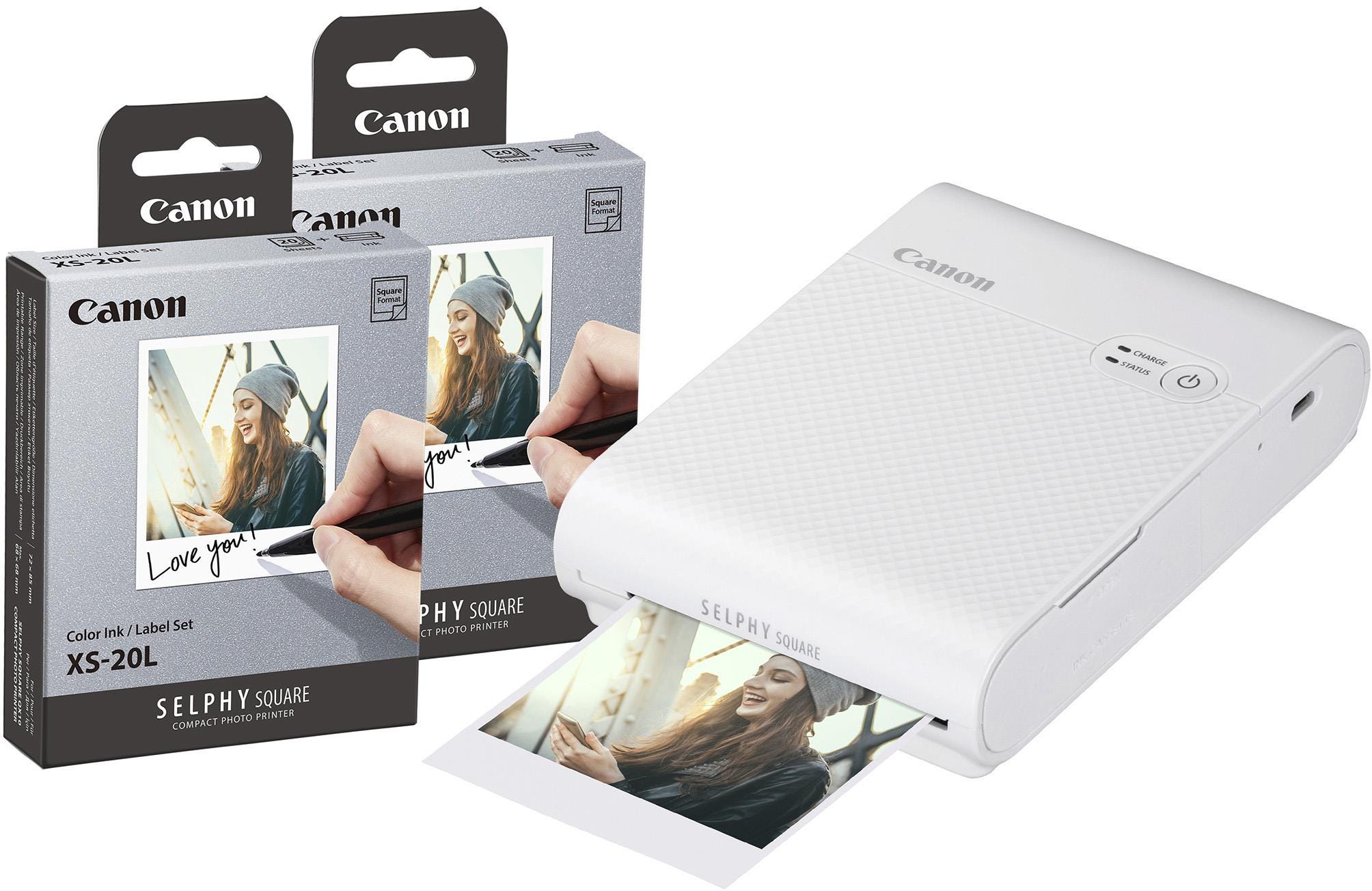 Canon Selphy Square QX10 wireless photo printer in white, featuring a sleek design, compact size, and includes two color ink label sets for printing 40 square photos.