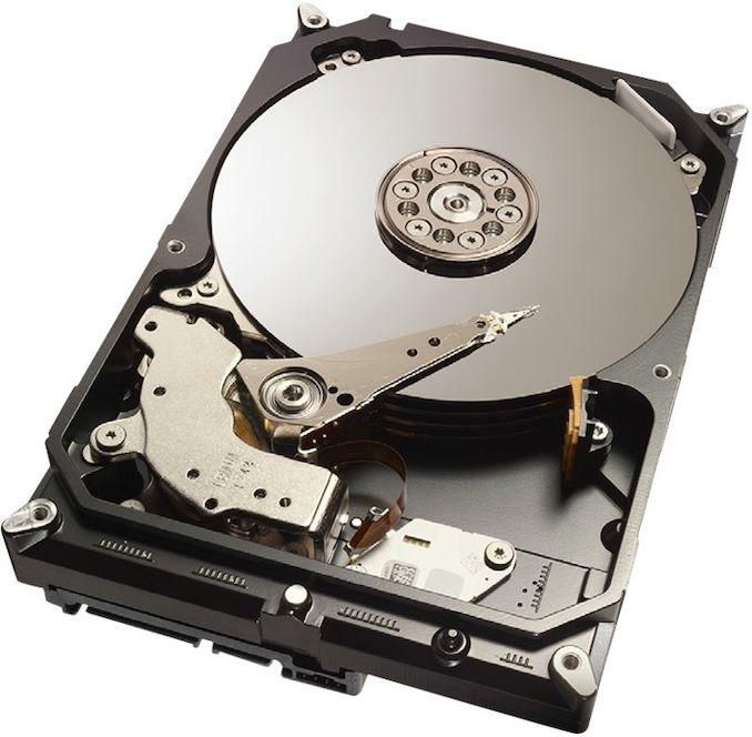 CoreParts IA2T2I253 internal hard drive with a sleek black metal casing, featuring a shiny silver disk and a gold arm mechanism, designed for 3.5" Serial ATA connections, 2 TB capacity.